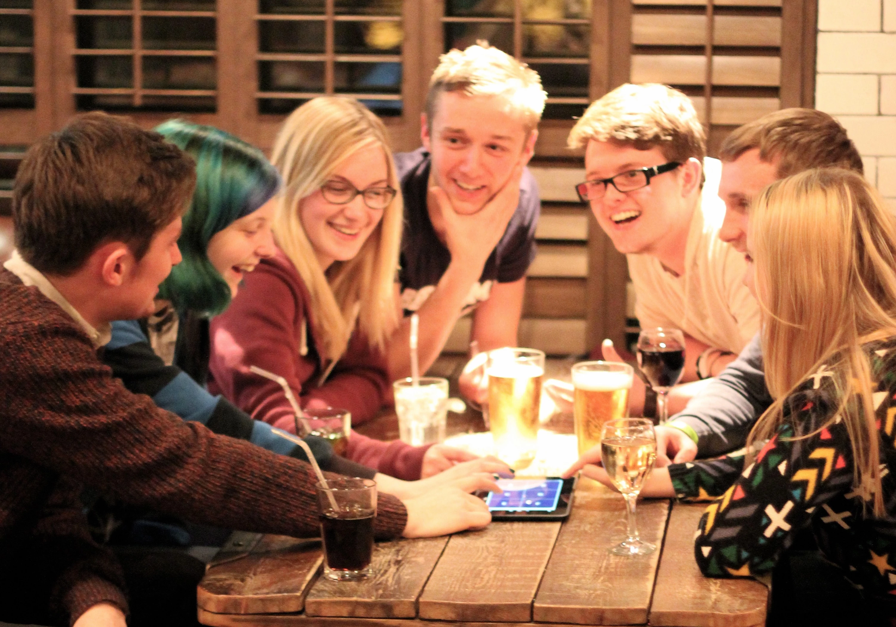 Group playing interactive trivia on a smartphone or tablet
